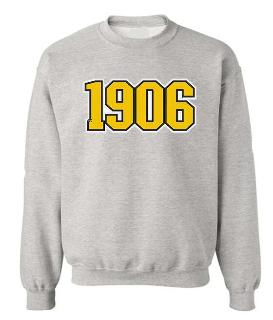 grey crewneck sweatshirt with gold 1906 embroidered across the chest.