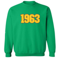Iota Phi Theta green sweatshirt with '1963' embroidered on it in gold against a brown background