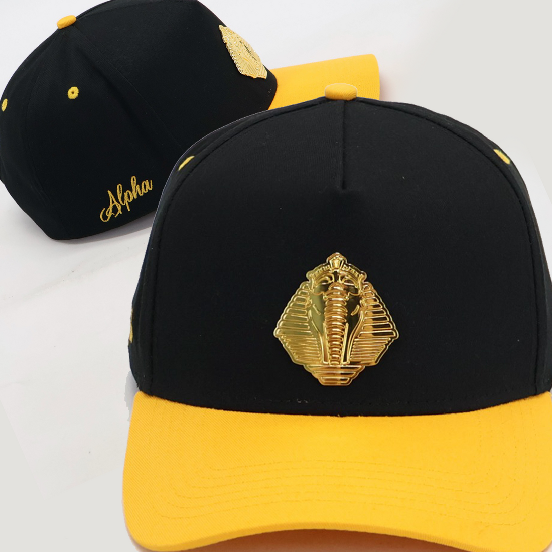 Black and yellow cap with a gold sphinx