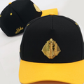 Black and yellow cap with a gold sphinx