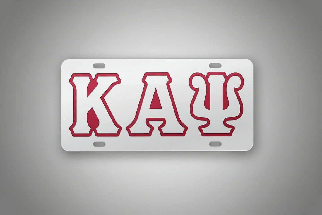 License plate with red letters 'KAP' on a gray background