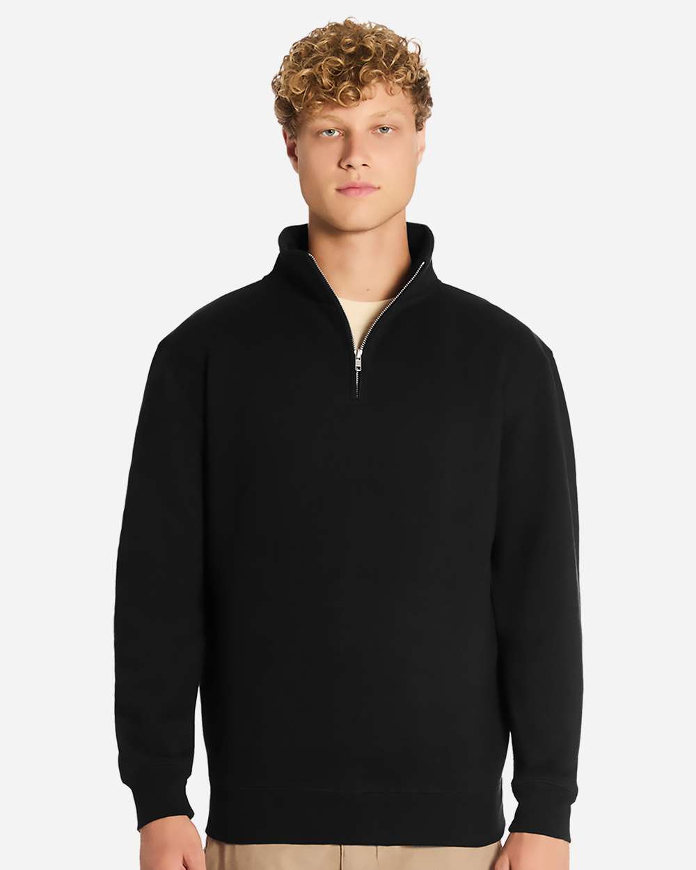 Man wearing a black quarter-zip sweatshirt on a white background