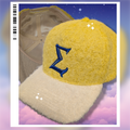 Yellow and cream hat with a blue sigma embroidered on it