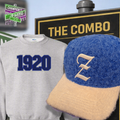 Gray sweatshirt with '1920' and blue fur hat with cream colored Z embroidered on it