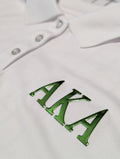 white polo with green metallic letters aka on the left chest