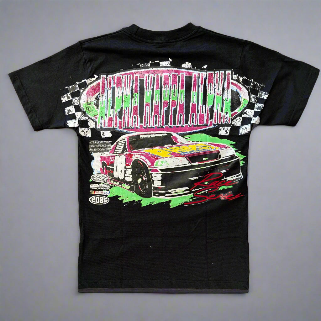 Black t-shirt with a colorful race car graphic on a wooden surface