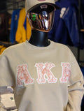 cream and pink crewneck