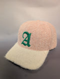 pink and cream hat with green A embroidered on ot