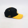 Black and yellow cap with 'Alpha' branding on a white background