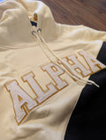 black and cream hoodie with 'ALPHA' embroidered on it