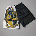 Pair of shorts with a crest design on a gray background