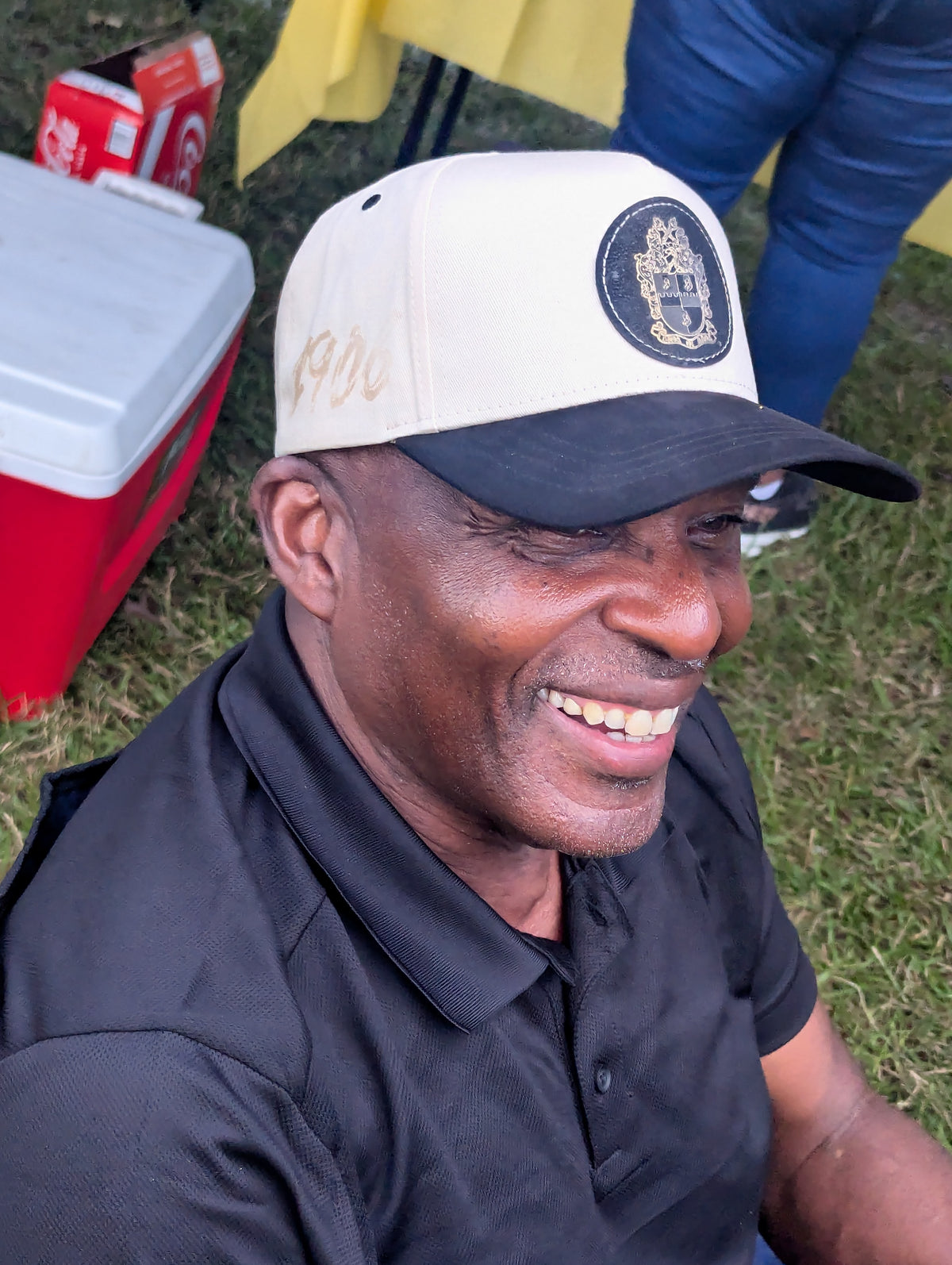 man wearing beige hat with black patch and black suede bill