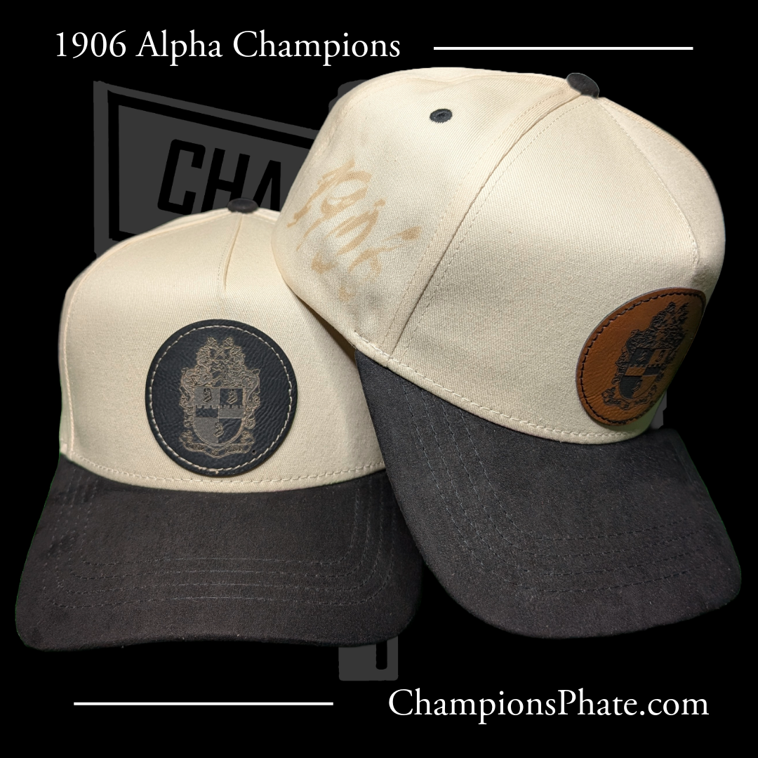 Two baseball caps with leather patches on a black background, featuring '1906 Alpha ' text.