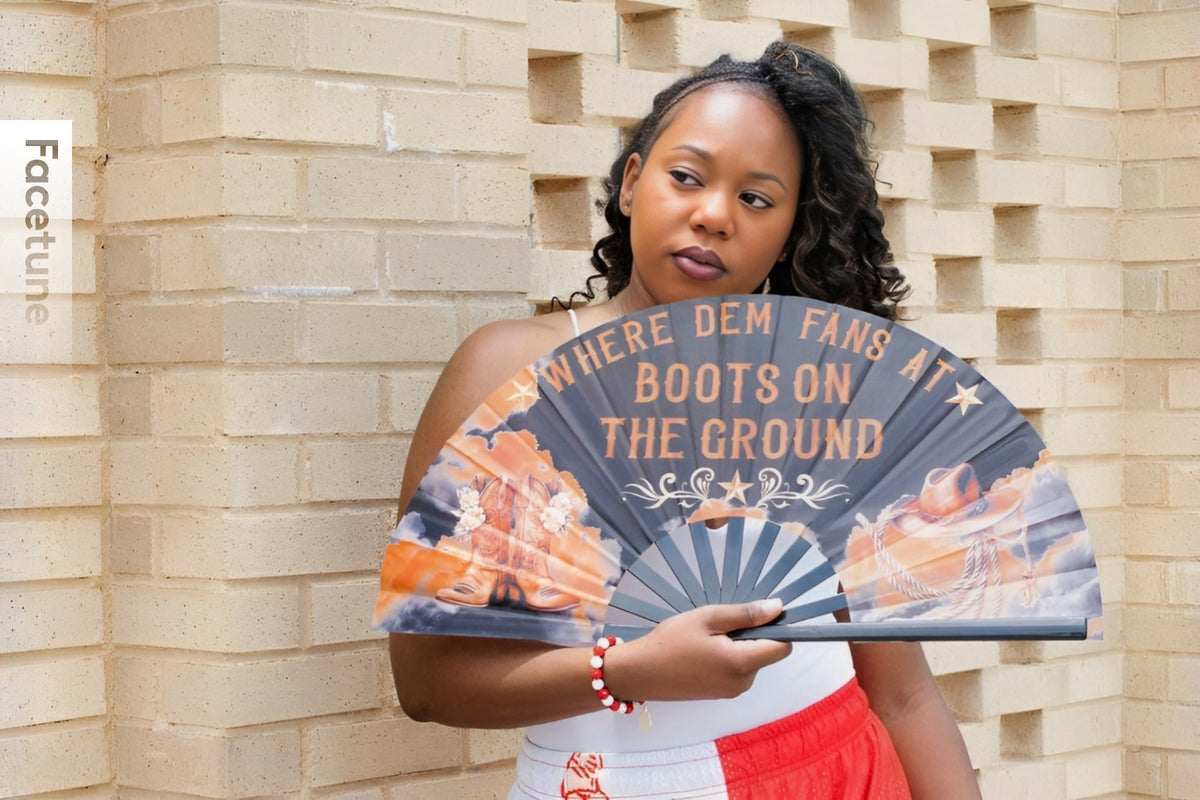 Woman holding a fan with text and graphics against a brick wall