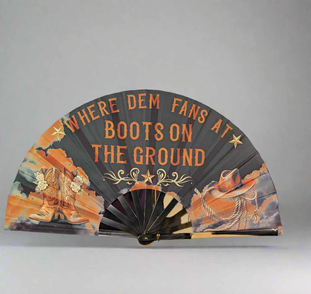 Decorative fan with cowboy design and text on a gray background