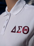 White polo shirt with red metallic letters on left chest