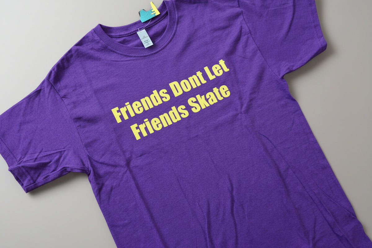 purple t-shirt with yellow text on a wooden surface