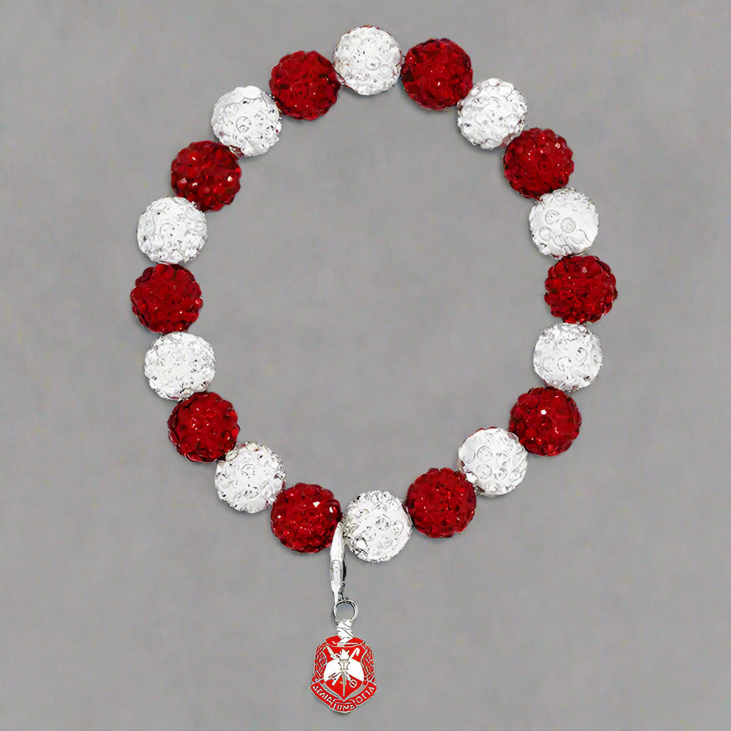 Bracelet with red and white beads and a pendant on a black background