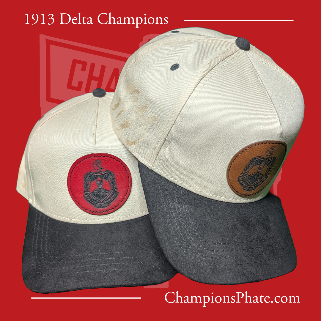 Two A-frame caps with suede brims, one main color is white and the other is black, featuring a red and a blue patch with crests, and a dark pin attached to each.
