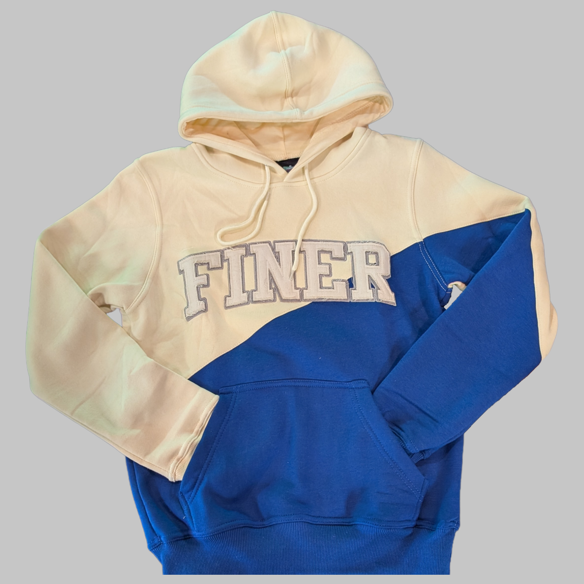 Two-tone hoodie with 'FINER' text on a gray background