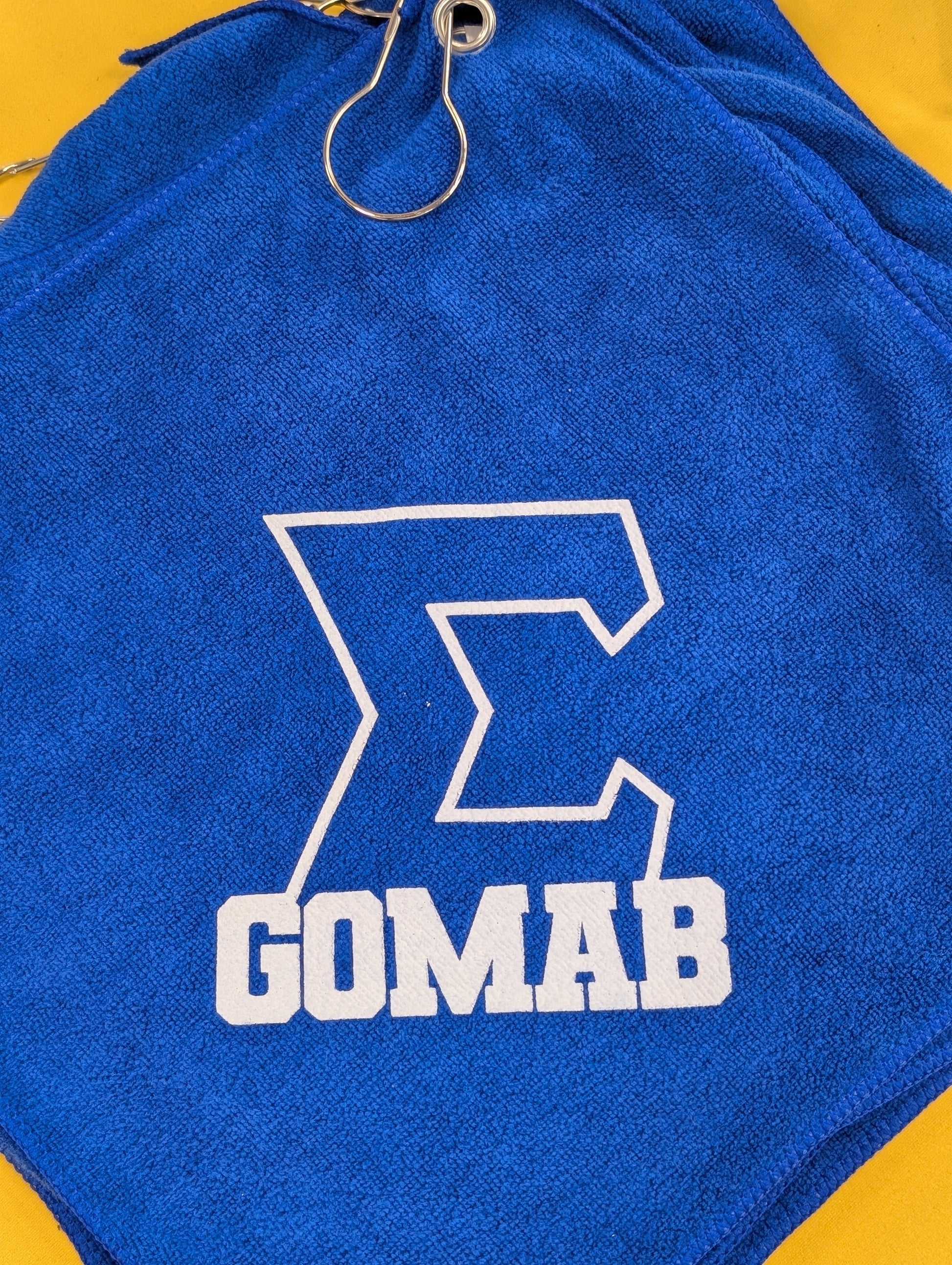 Blue towel with a white text "gomab" 