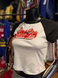 Mannequin wearing a white and black shirt with red text in a store setting