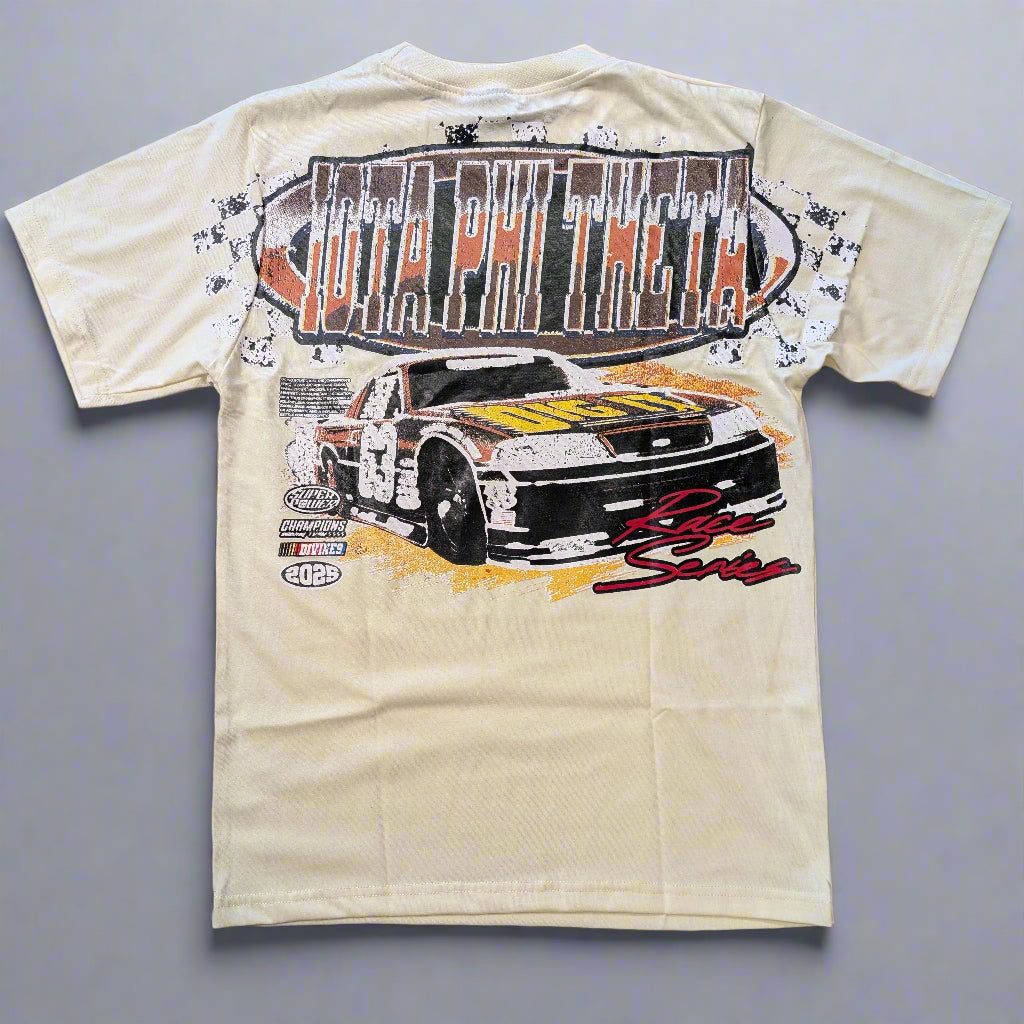 Beige t-shirt with a graphic of a race car and text on a wooden surface