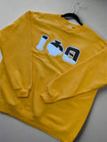 Yellow sweatshirt with graphic design on a gray background