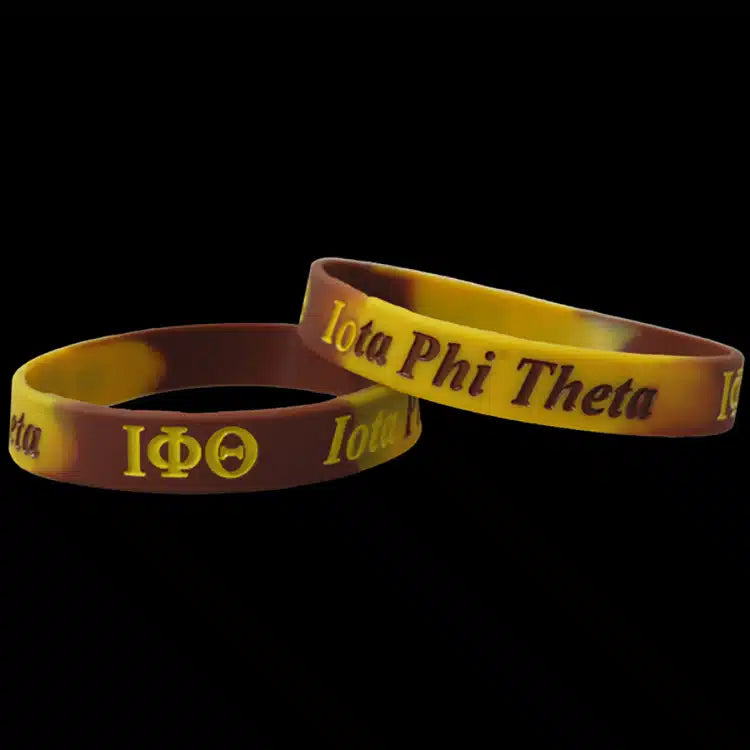Two Iota Phi Theta rubber bracelets on a black background
