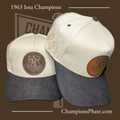 Two baseball caps with leather patches and '1963 Iota ' text on a brown background.