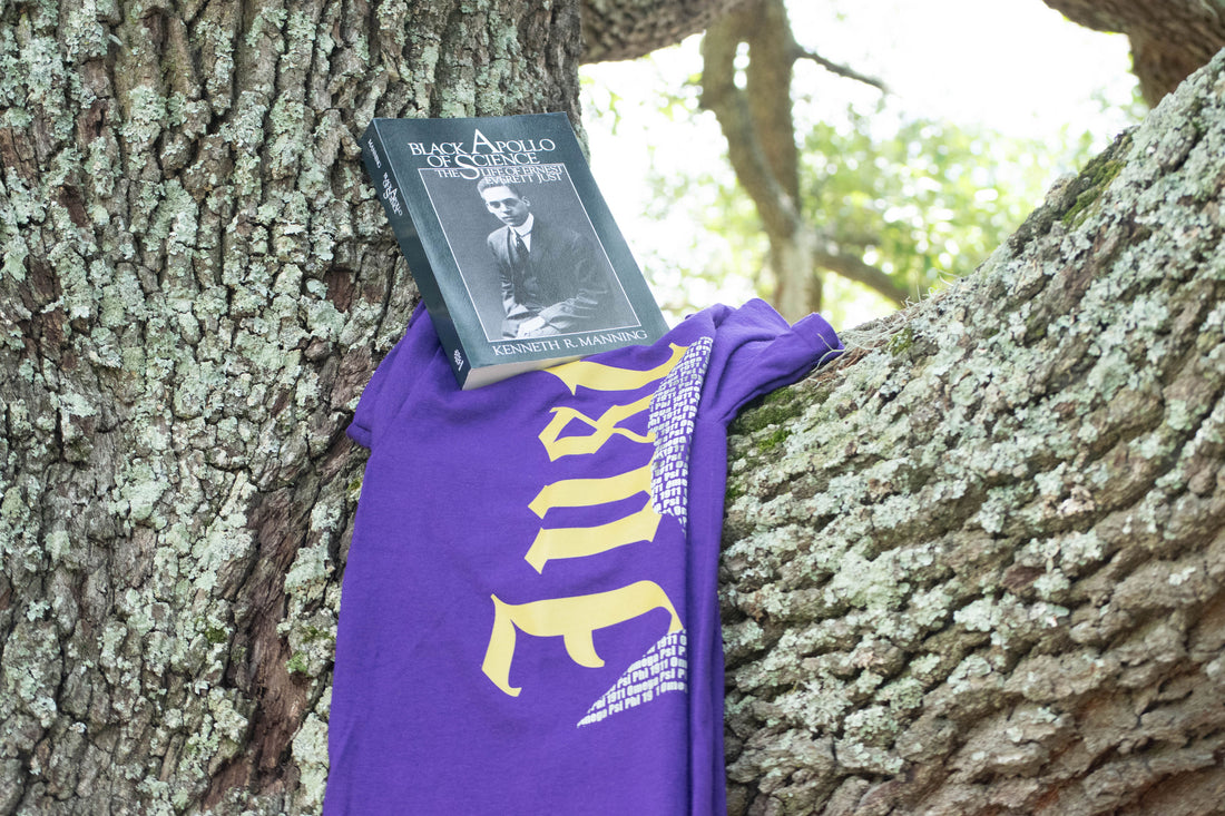 Purple t-shirt with a graphic design featuring a portrait and text on a white background