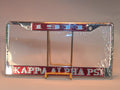Kappa Alpha Psi license plate frame on a stand with clear plastic wrap.
