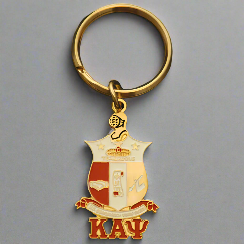 Keychain with a shield design and 'KAΨ' letters on a black background