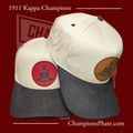 Two A-frame caps with suede brims, one in beige and the other in a darker color, featuring pins and an engraved design on the front.