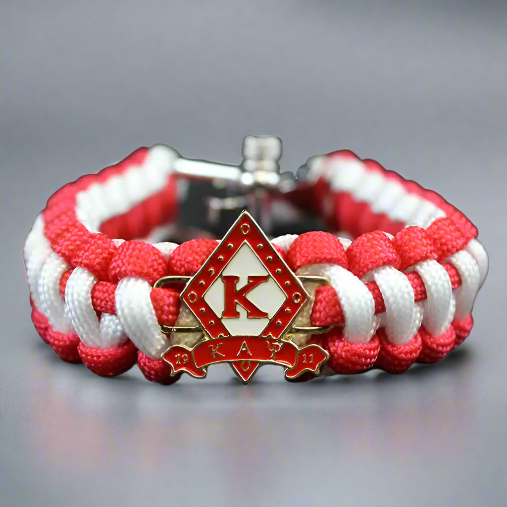 Red and white braided bracelet with a Kappa Alpha Psi emblem 