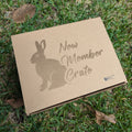 Cardboard box labeled 'New Member Crate' with a rabbit silhouette on grass