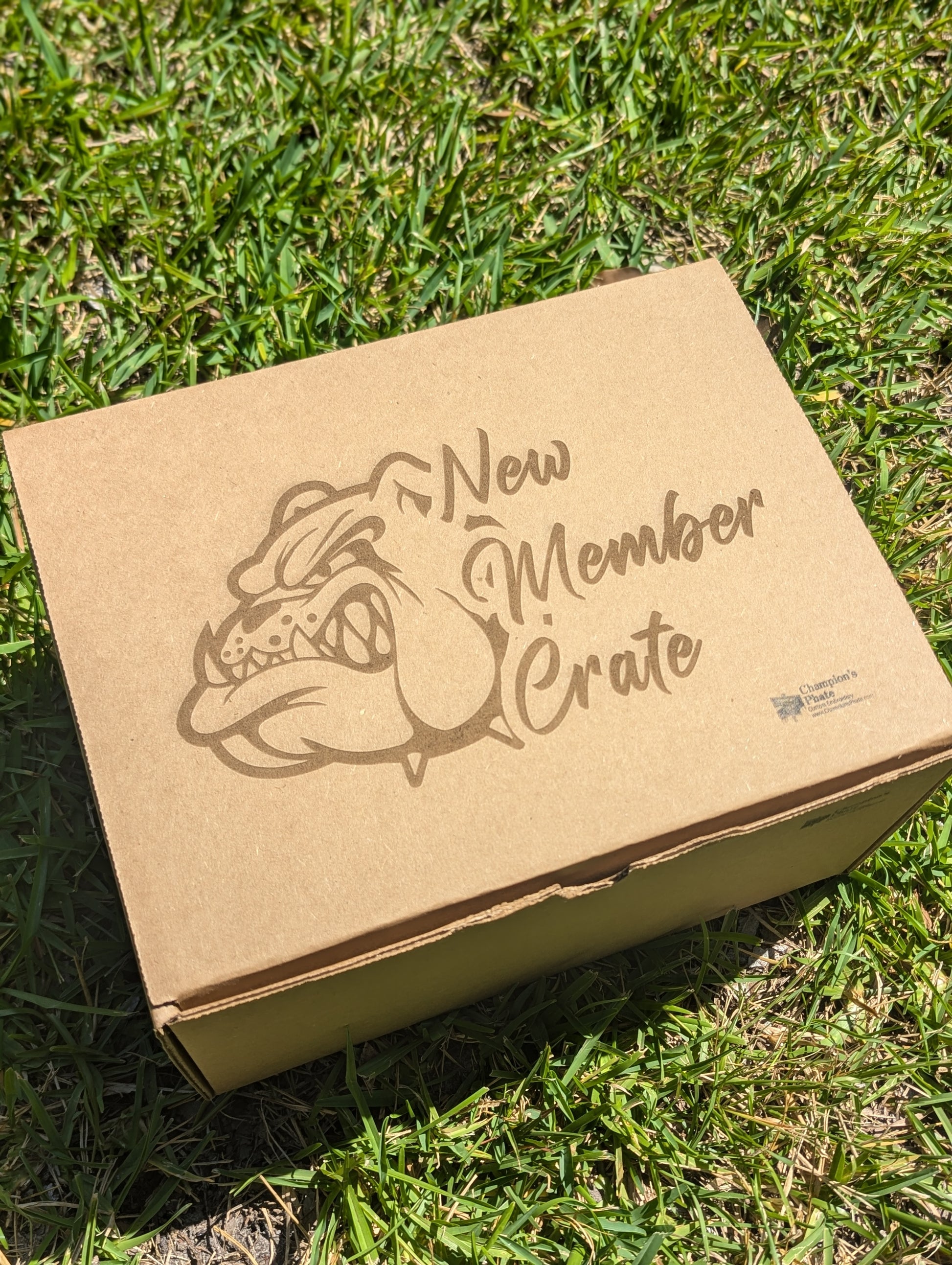 Cardboard box with 'New Member Crate' and bulldog