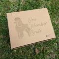 A cardboard gift crate with 'NEW MEMBER CRATE' printed on top and the silhouette of a poodle