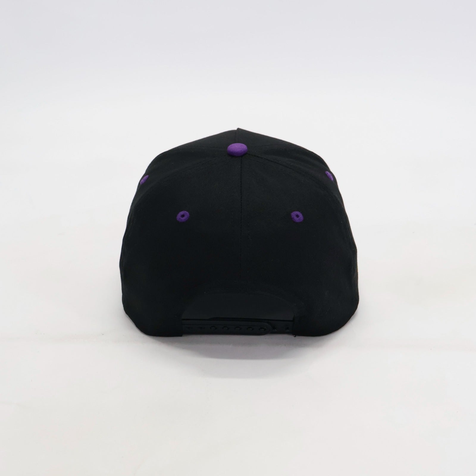 Black cap with purple eyeletson a white background