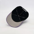 Black and beige cap with 'Chris' text on inner cap