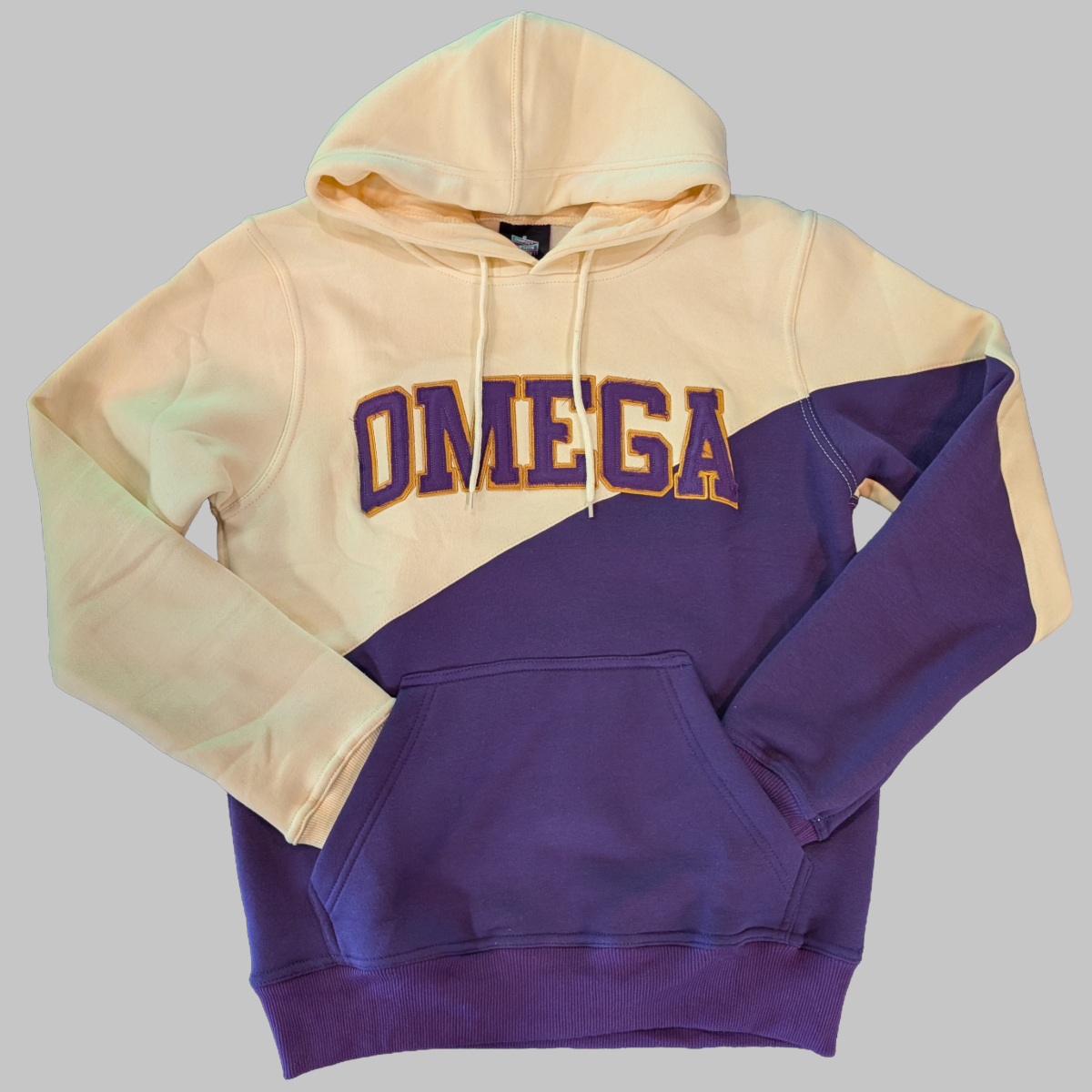 Two-tone beige and purple hoodie with 'OMEGA' text trimmed in old gold