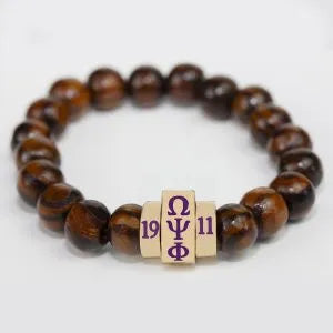 Brown wooden beaded bracelet with a cylindrical metal charm featuring 'ΩΨΦ' and founding year