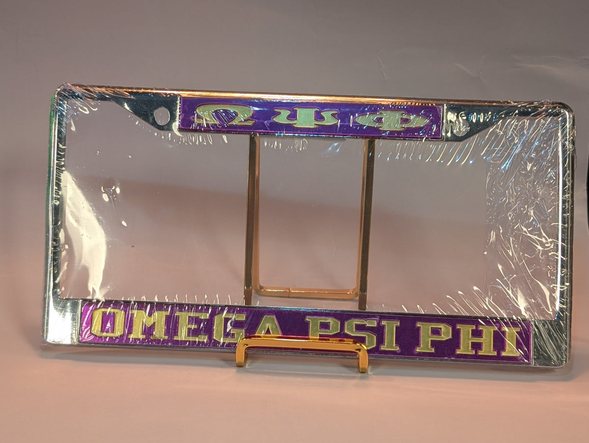 Omega Psi Phi license plate frame on a stand with clear plastic wrap.