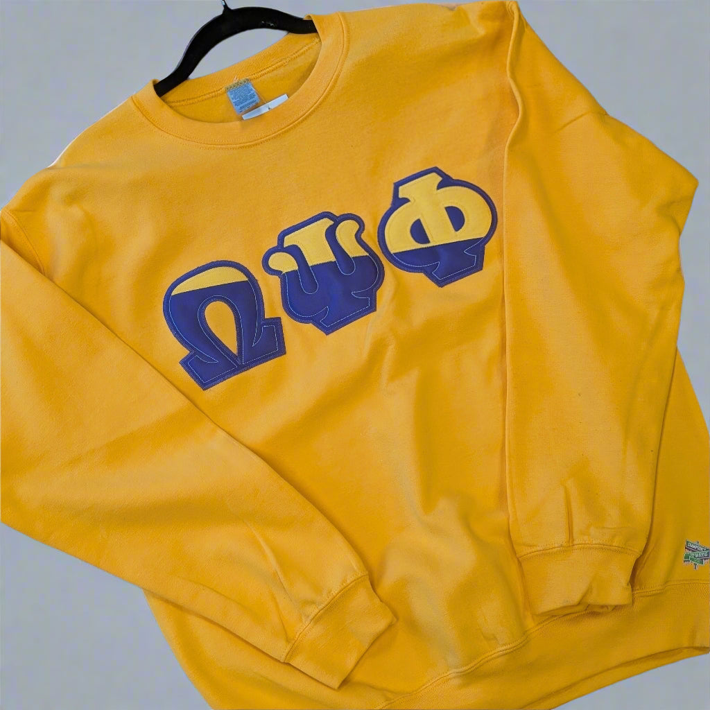 Yellow sweatshirt with blue and yellow symbols on a gray background