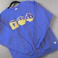 purple sweatshirt with yellow graphics on a wooden surface