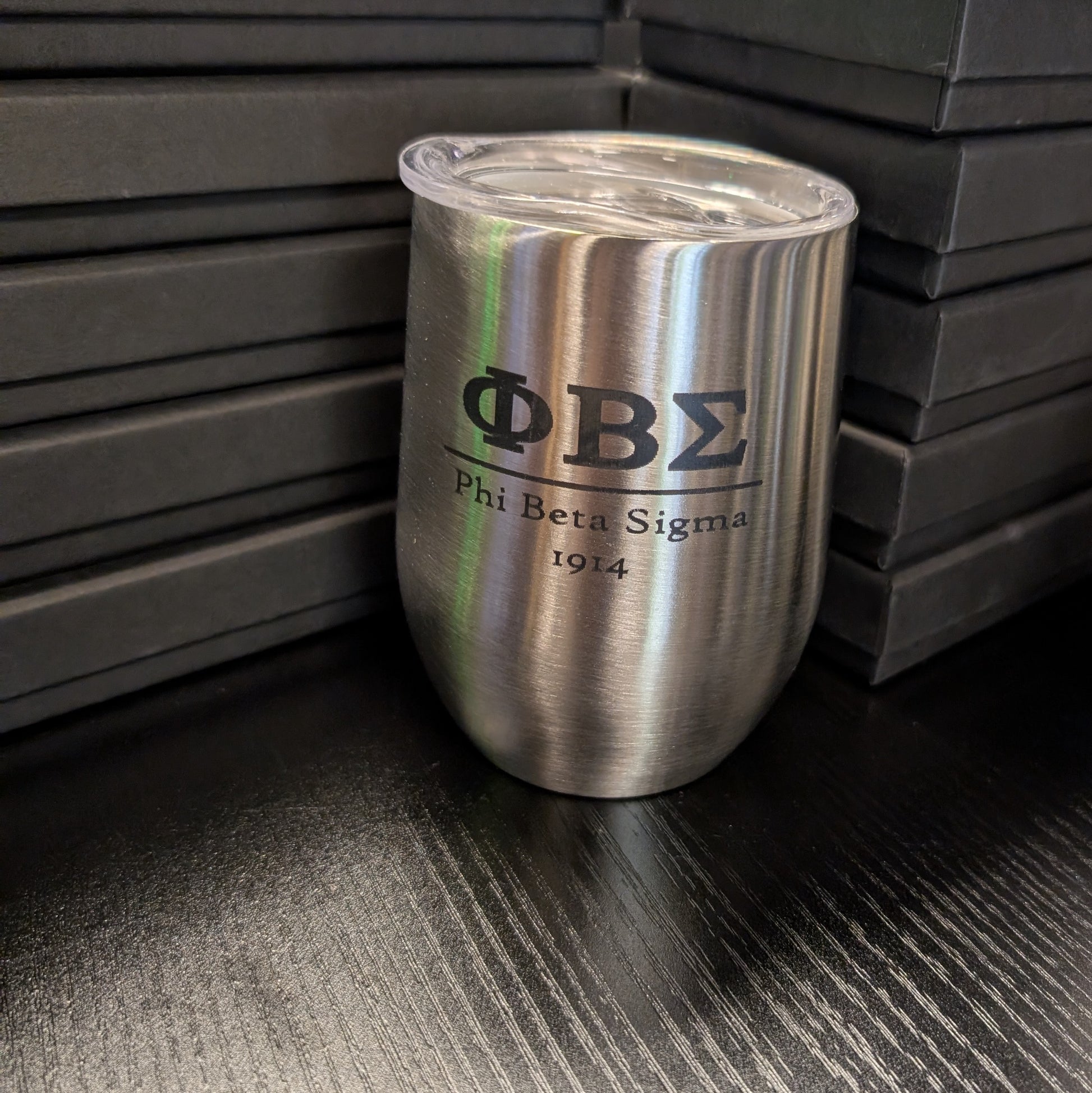 Stainless steel tumbler with Phi Beta Sigma logo on a dark surface