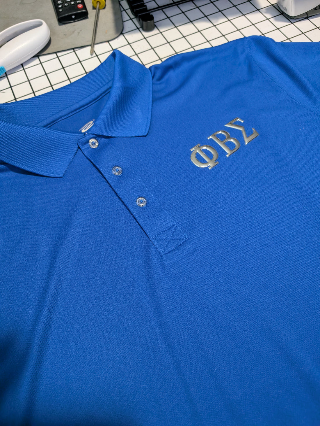 blue polo with silver metallic greek letters phi beta sigma