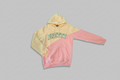 Two-tone cream and pink hoodie with 'Pretty' text trimmed in green