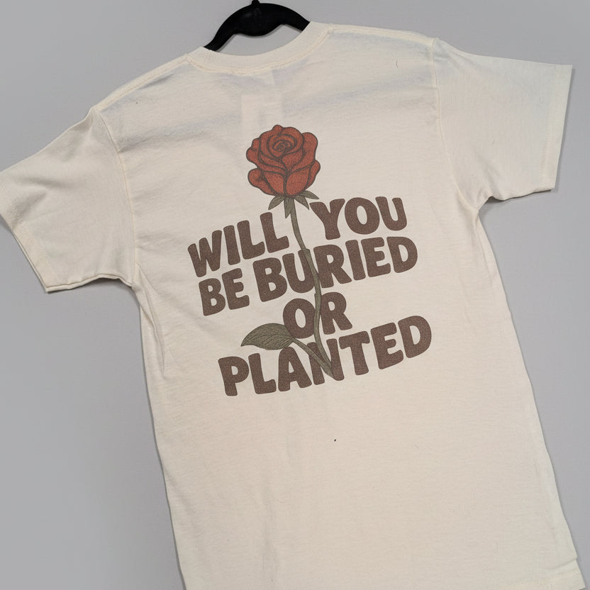 Beige t-shirt with a casket with rose growing from top and roots growing from bottom