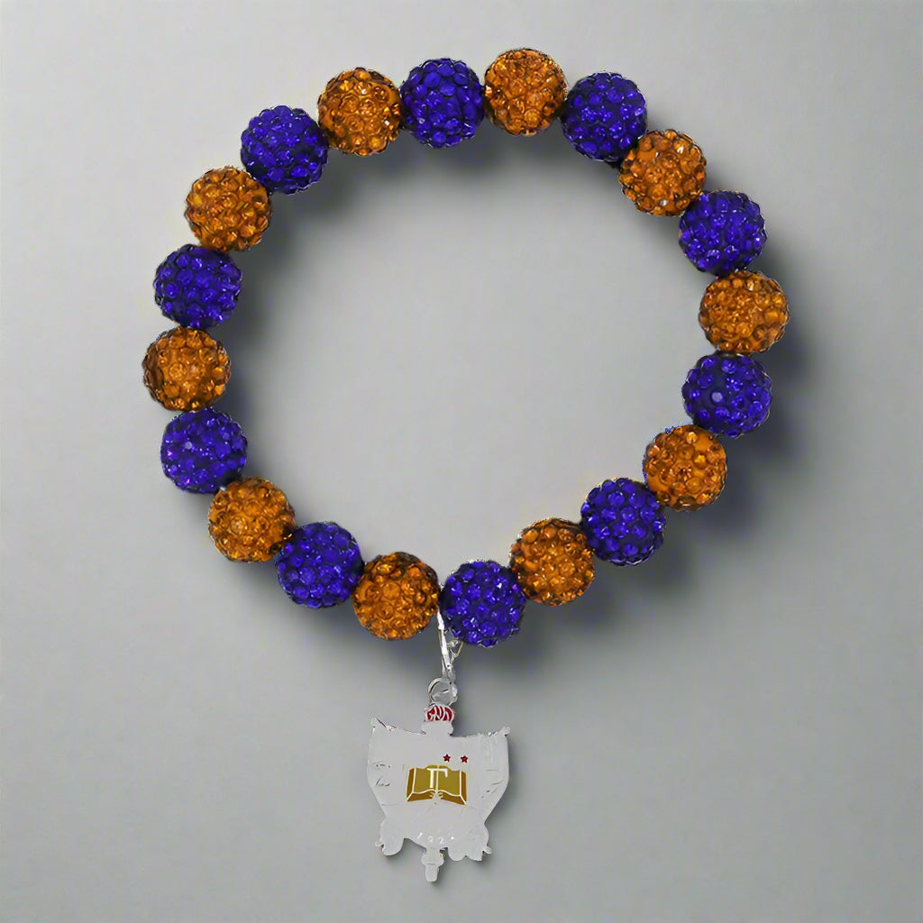 Bracelet with blue and orange beads and a silver charm on a black background